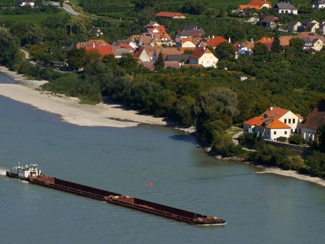 Remorkér tlačí náklad rakúskym údolím Wachau. Známy vinársky región s unikátnou mikroklímou je zaradený do zoznamu UNESCO.