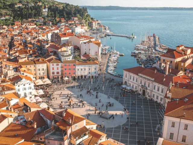 Beautiful aerial view on Piran town with Tartini main square, ancient buildings with red roofs and Adriatic sea in southwestern Slovenia